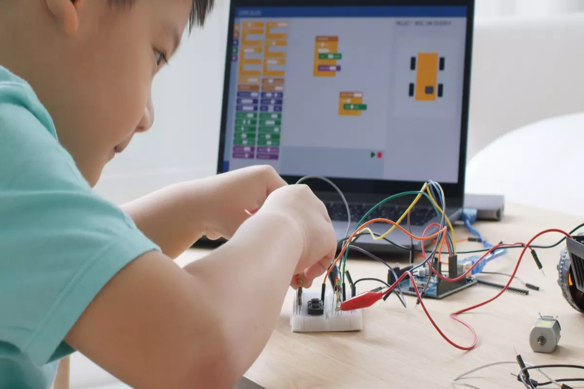 child working on something with wires